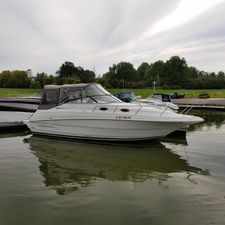 Monterey 262 Cruiser 2001 Monterey 262 Cruiser boat docked on calm fresh water, surrounded by greenery.