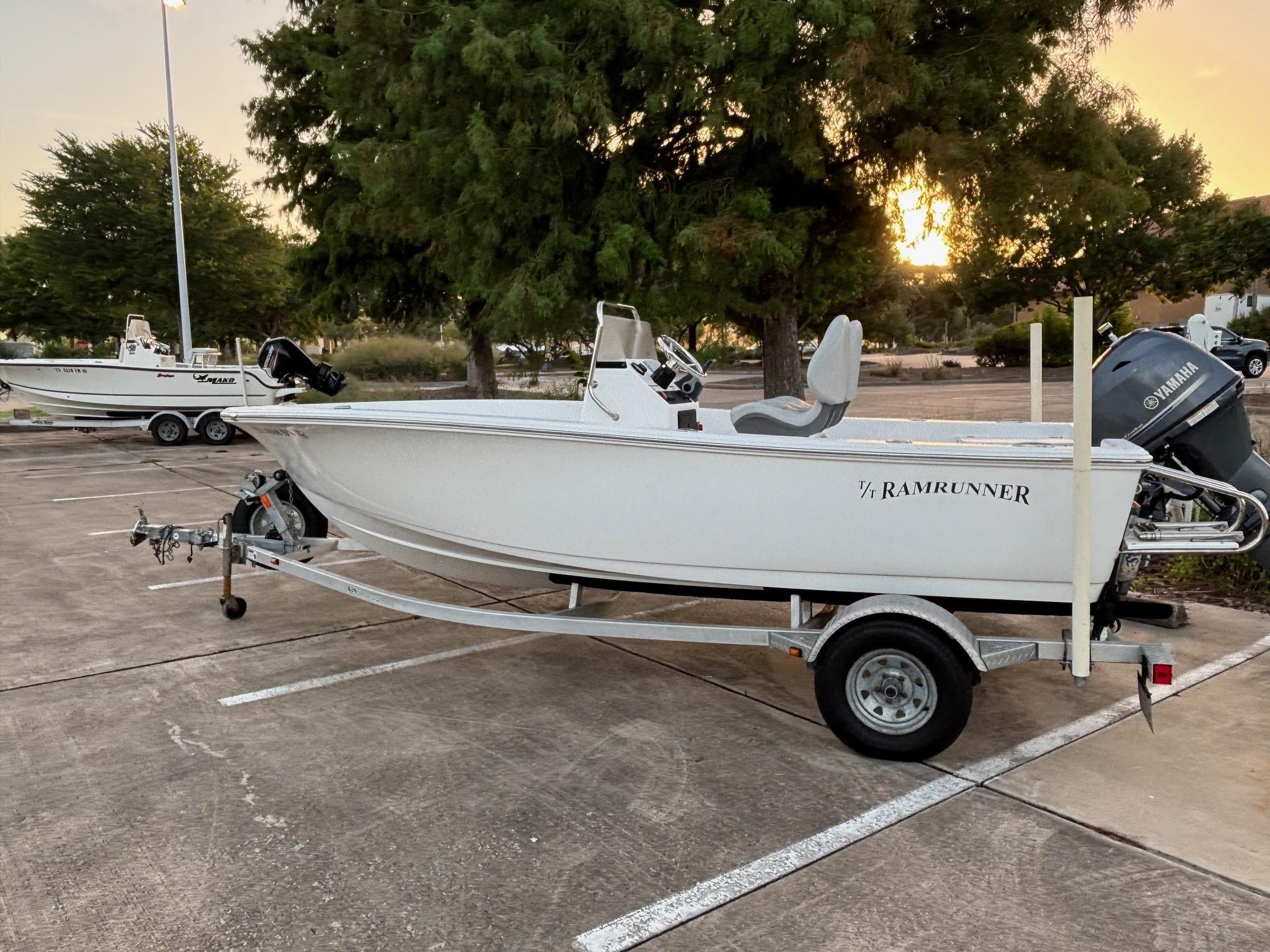Sportsman Island Reef 17 Center Console 2016 Sportsman Island Reef 17 Center Console boat on trailer in parking lot at sunset.