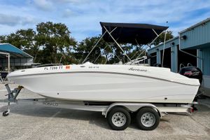 Hurricane Sundeck Sport 218 OB 2024 Hurricane Sundeck Sport 218 OB boat on trailer, parked outdoors.