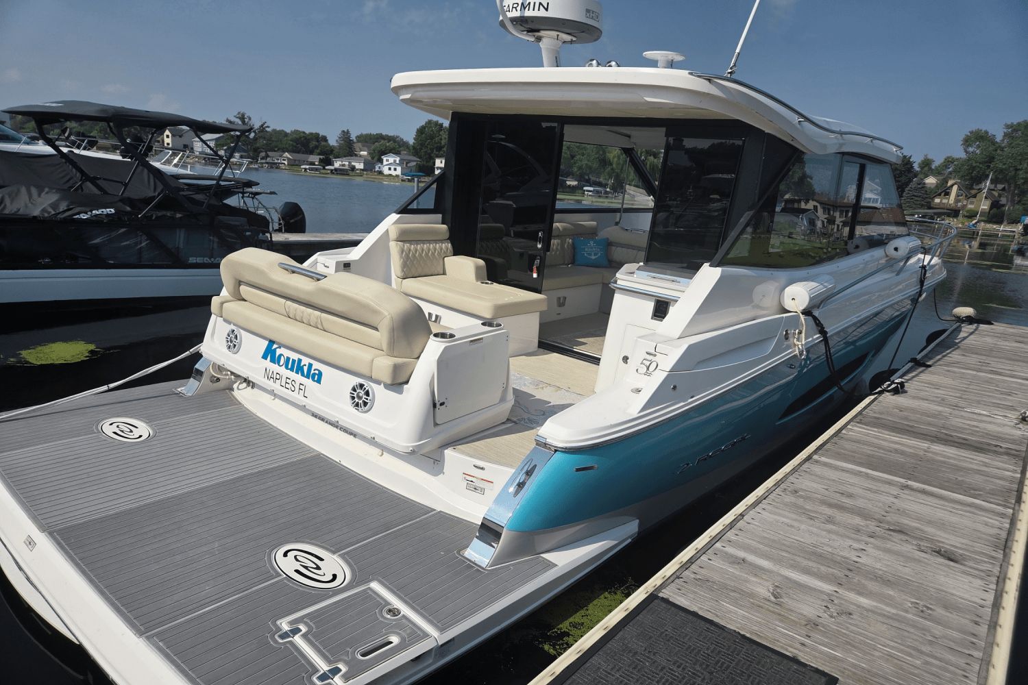 Regal 36 Grande Coupe 2022 Regal 36 Grande Coupe docked, featuring sleek design and spacious deck.