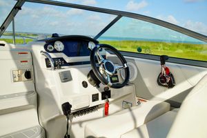Regal 26 Express 2019 Regal 26 Express boat cockpit with steering wheel and control panel.
