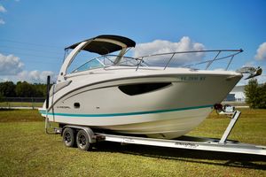 Regal 26 Express 2019 Regal 26 Express boat on trailer, parked on grass under a clear sky.
