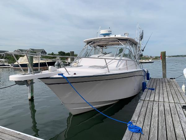 Grady-White 330 Express 2001 Grady-White 330 Express boat docked at marina, clear sky background.