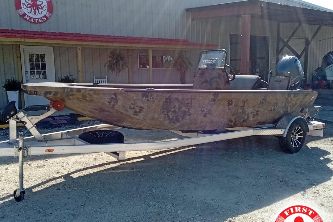 Thor 1900 Lake Hammer 2025 Thor 1900 Lake Hammer boat on trailer outside a building.