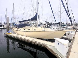 Island Packet 35 1990 Island Packet 35 sailboat docked at marina, surrounded by other boats.