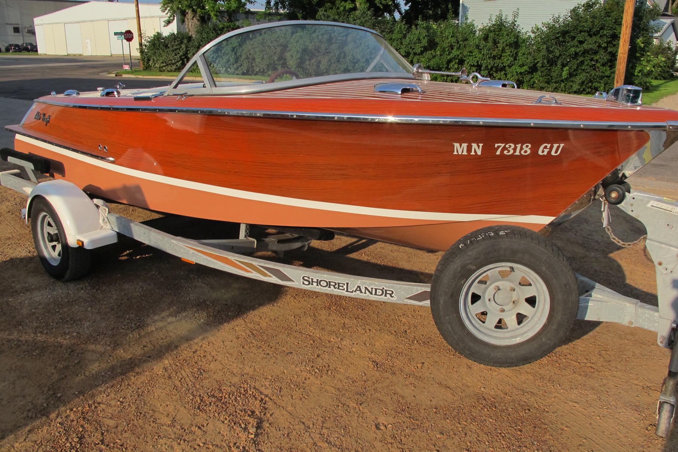 Elite Craft Riviera 1989 Elite Craft Riviera boat on trailer, showcasing classic wooden design.