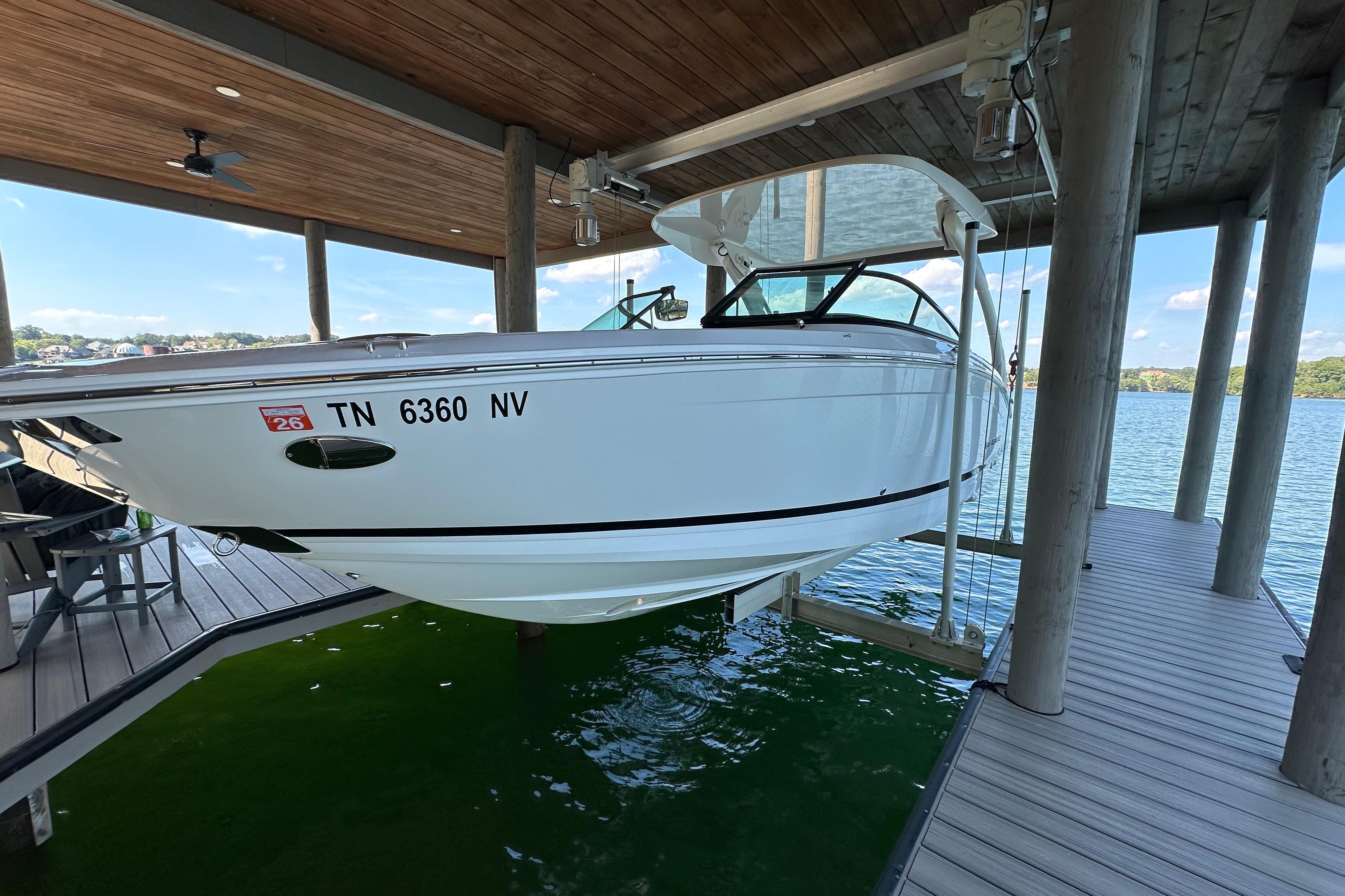 Regal LS6 2022 Regal LS6 boat docked in a covered marina, side view.