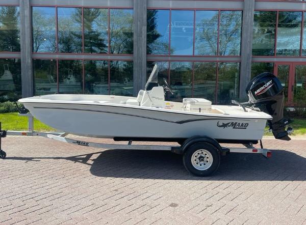 Mako Pro Skiff 15 CC 2025 Mako Pro Skiff 15 CC boat on trailer, parked outdoors.