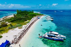 Axopar 37 Sun Top Coastal scene with 2021 Axopar 37 Sun Top boats anchored on a tropical beach.