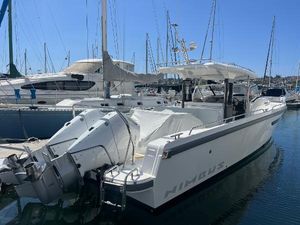 Nimbus T11 2024 Nimbus T11 boat docked in marina, featuring dual outboard motors.