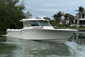Grady-White Canyon 456 2024 Grady-White Canyon 456 boat cruising on a calm waterway near luxury homes.