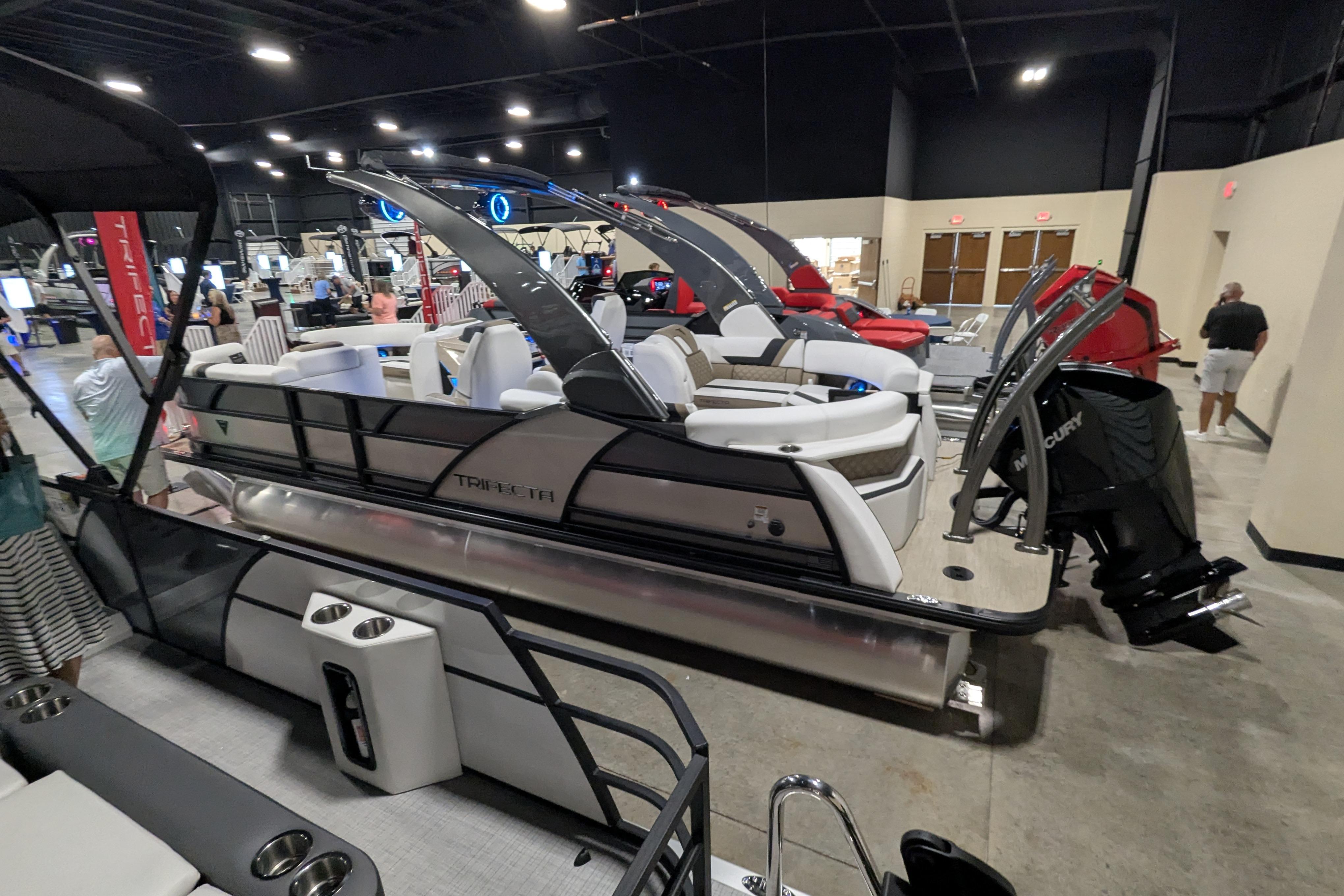 Trifecta 23RFSS 2026 Trifecta 23RFSS pontoon boat displayed indoors at a boat show.