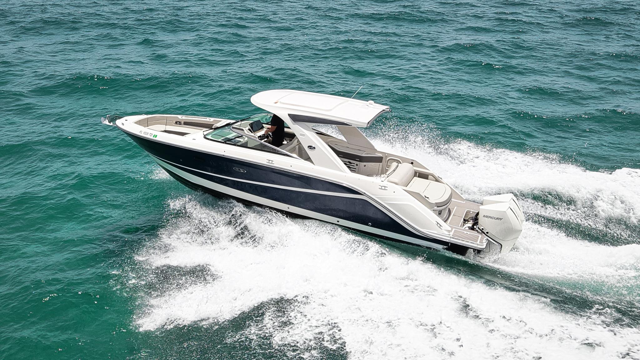 Sea Ray SLX 310 Outboard 2022 Sea Ray SLX 310 Outboard cruising on open water, showcasing sleek design and performance.