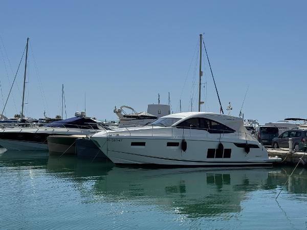 Fairline Targa 48 Open 2017 Fairline Targa 48 Open yacht docked in a marina under clear blue skies.