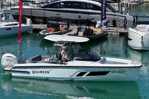 Quarken 27 T-Top 2024 Quarken 27 T-Top boat docked in marina, featuring sleek design and Yamaha engine.