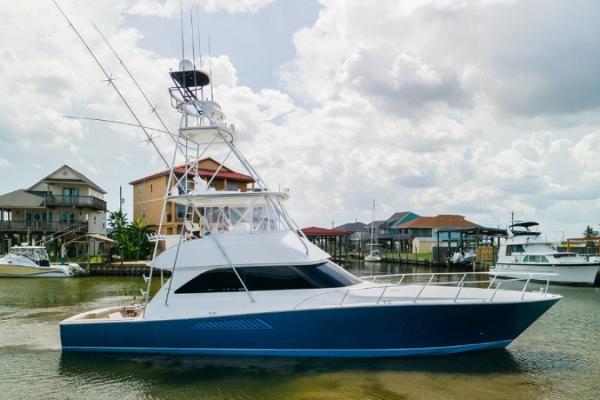 Viking 52 Convertible 2007 Viking 52 Convertible yacht docked in a marina under cloudy skies.