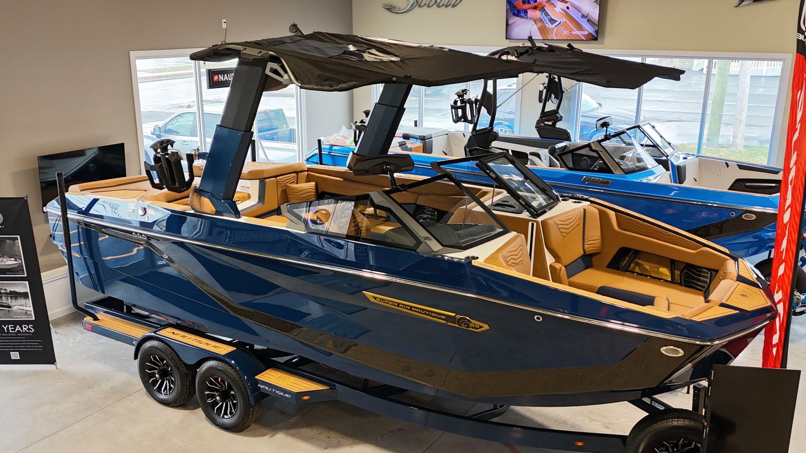 Nautique G23 2025 Nautique G23 boat in showroom, featuring sleek design and luxurious interior.