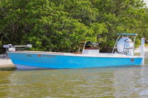 Willy Roberts 20 Hemingway Edition 2021 Willy Roberts 20 Hemingway Edition boat docked by lush greenery.