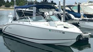 Cobalt R5 2016 Cobalt R5 boat docked in marina with blue canopy.