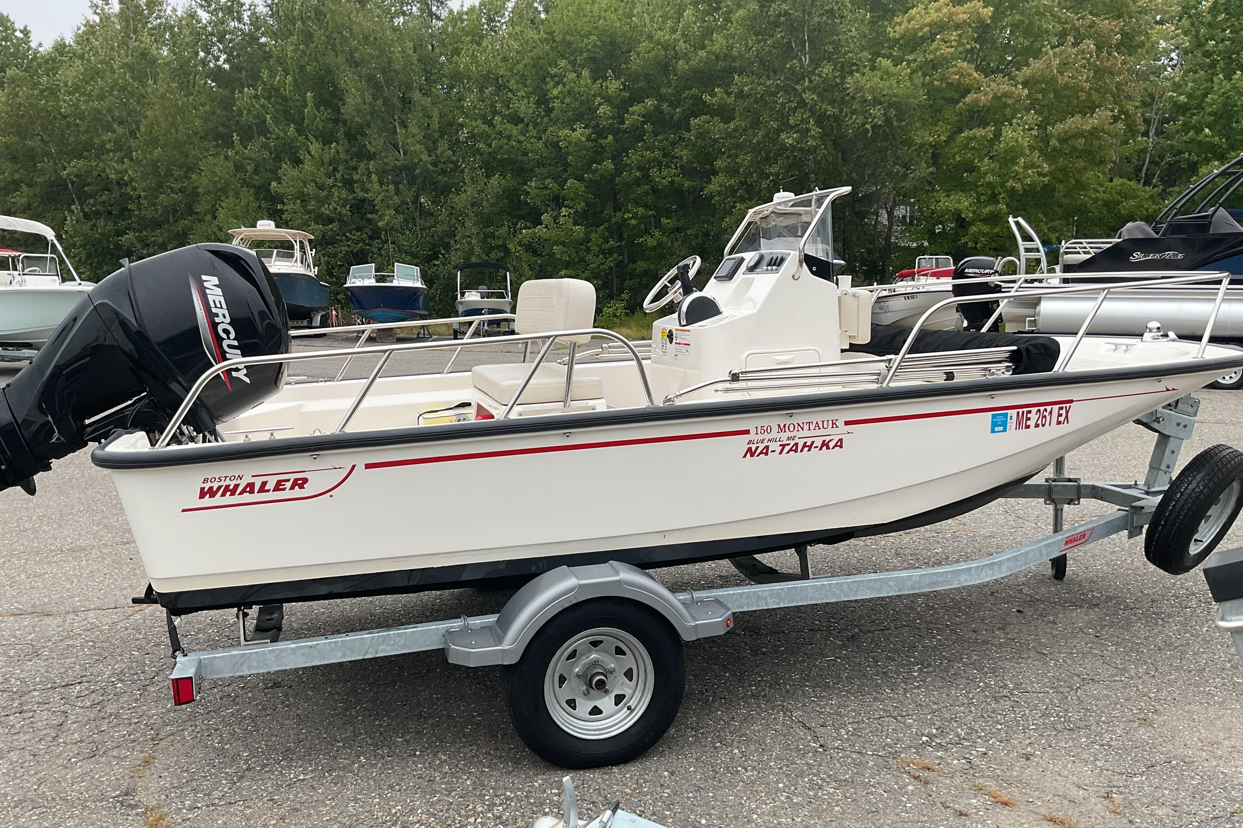Boston Whaler 150 Montauk 2024 Boston Whaler 150 Montauk boat on trailer, parked outdoors.