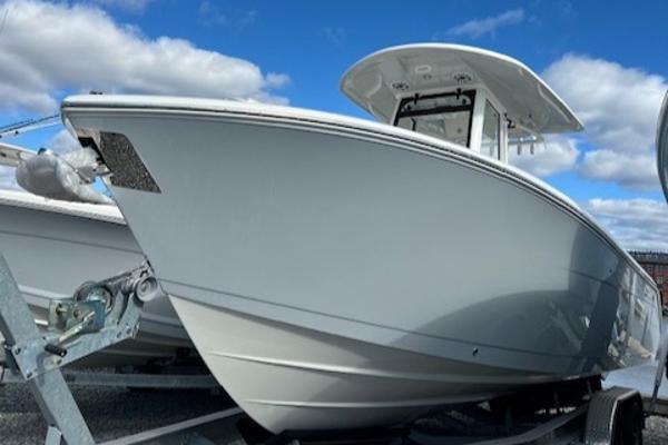 Cobia 265 Open Center Console 2025 Cobia 265 Center Console Open boat on trailer under blue sky.