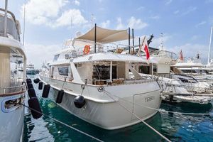 Custom Steel Translatlantic Navetta Custom Steel Transatlantic Navetta yacht, 2022 model, docked in a marina under a clear sky.