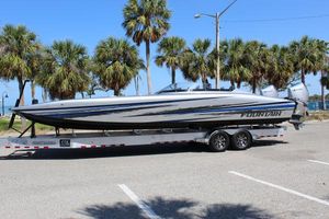 Fountain 34 Thundercat 2025 Fountain 34 Thundercat boat on trailer, parked near palm trees under clear blue sky.