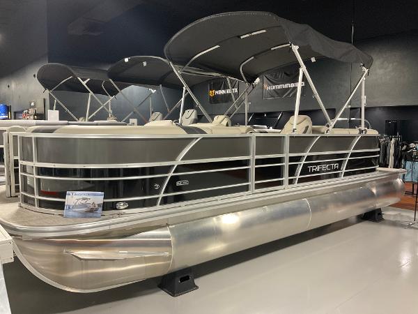 Trifecta 24 RF LE 2023 Trifecta 24 RF LE pontoon boat with canopy in showroom.