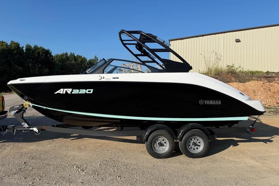 Yamaha Boats AR220 2026 Yamaha Boats AR220 on trailer, black and white design, parked outdoors.