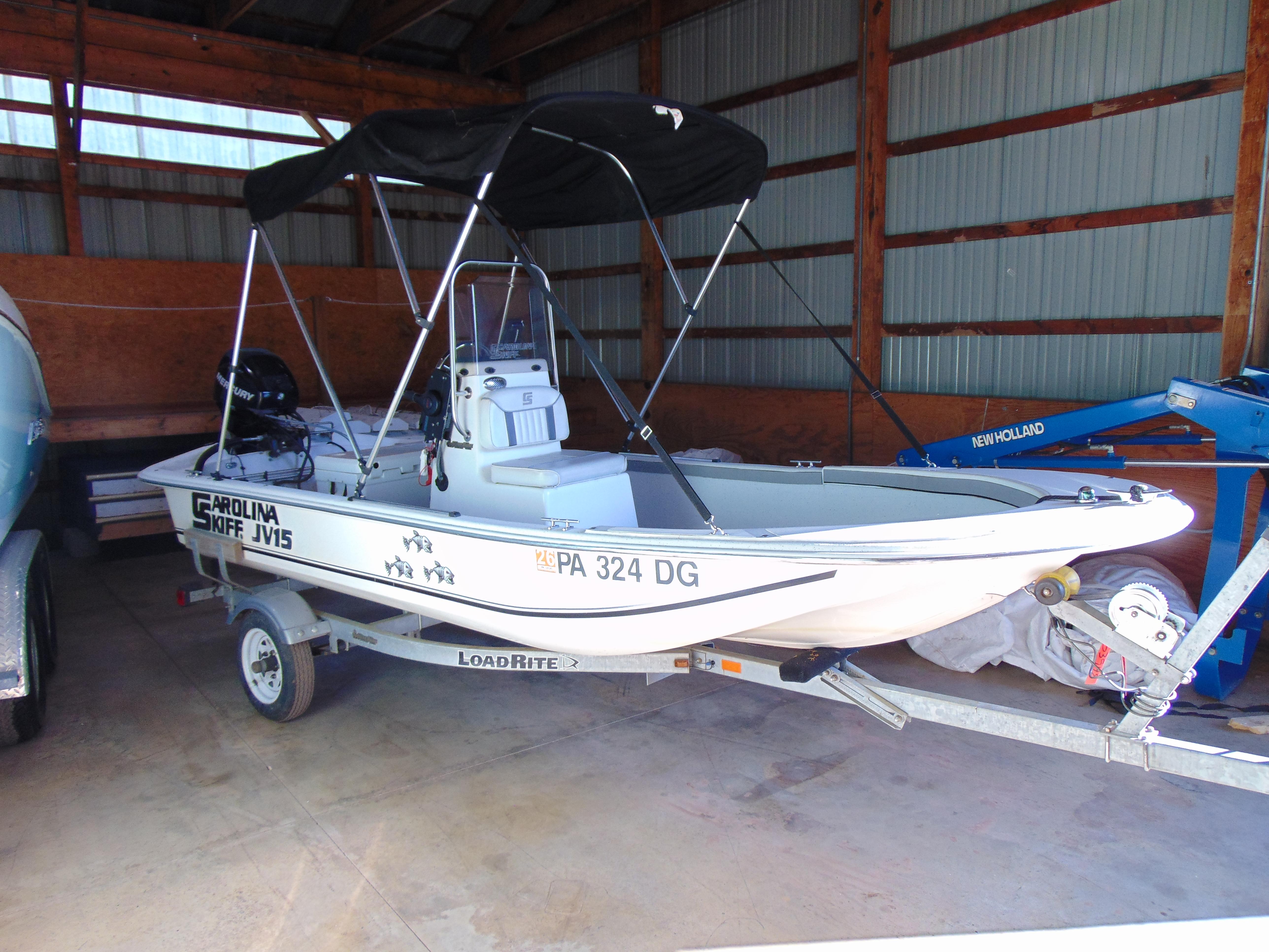 Carolina Skiff JV15CC 2011 Carolina Skiff JV15CC boat on trailer in storage shed.