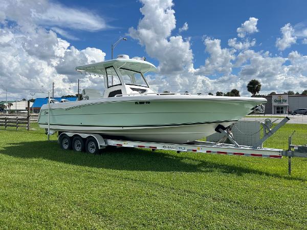 Stamas 33T Aventura 2022 Stamas 33T Aventura boat on trailer, parked on grass under blue sky.