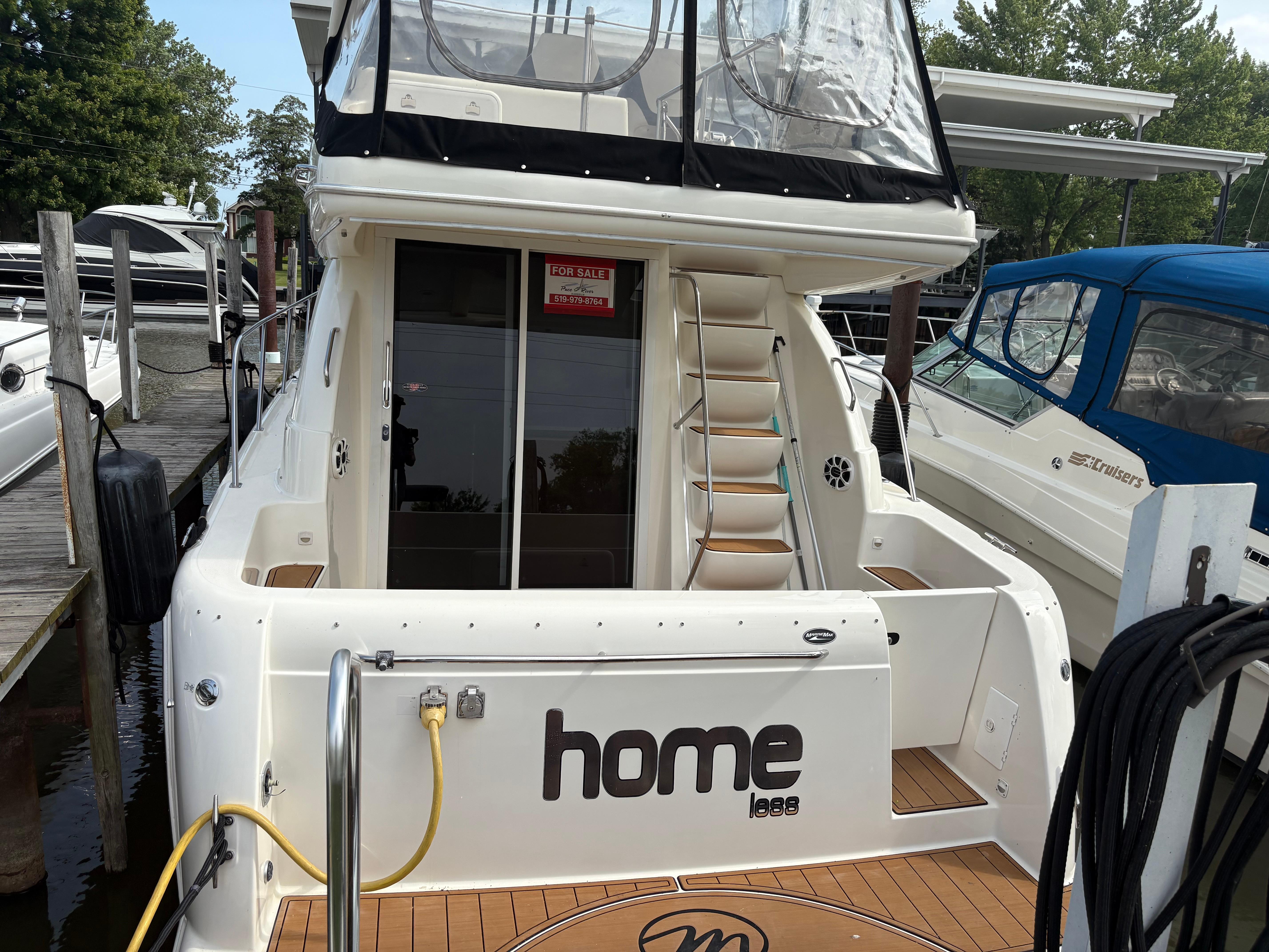 Meridian 341 Sedan 2003 Meridian 341 Sedan yacht docked, featuring "Home less" name and "For Sale" sign.