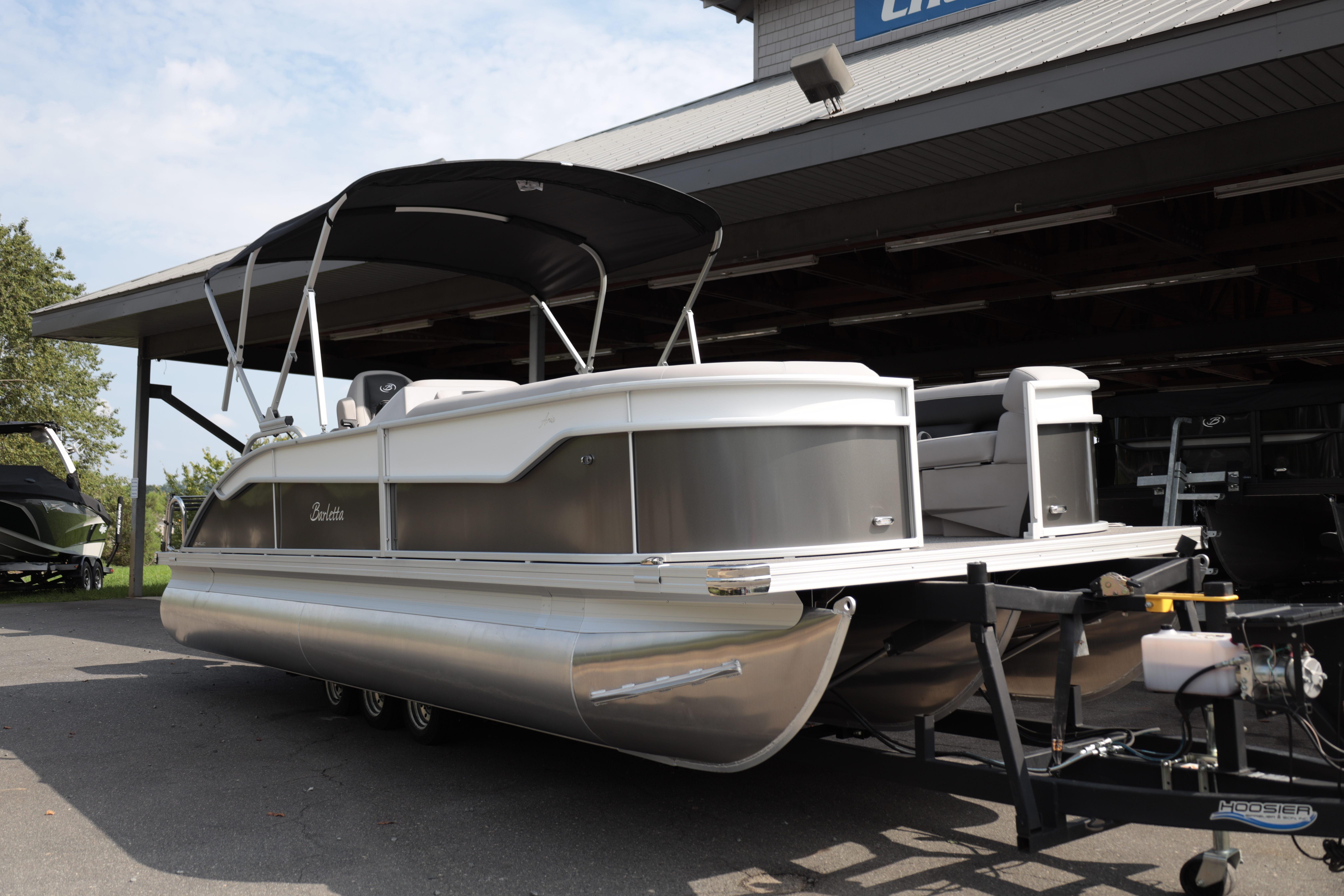 Barletta ARIA 22UC 2026 Barletta ARIA 22UC pontoon boat on trailer, parked under a shelter.