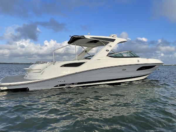 Sea Ray 350 SLX 2016 Sea Ray 350 SLX boat cruising on open water under a blue sky.
