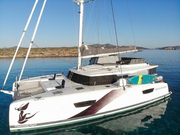 Fountaine Pajot Tanna 47 2023 Fountaine Pajot Tanna 47 catamaran sailing on clear blue water.