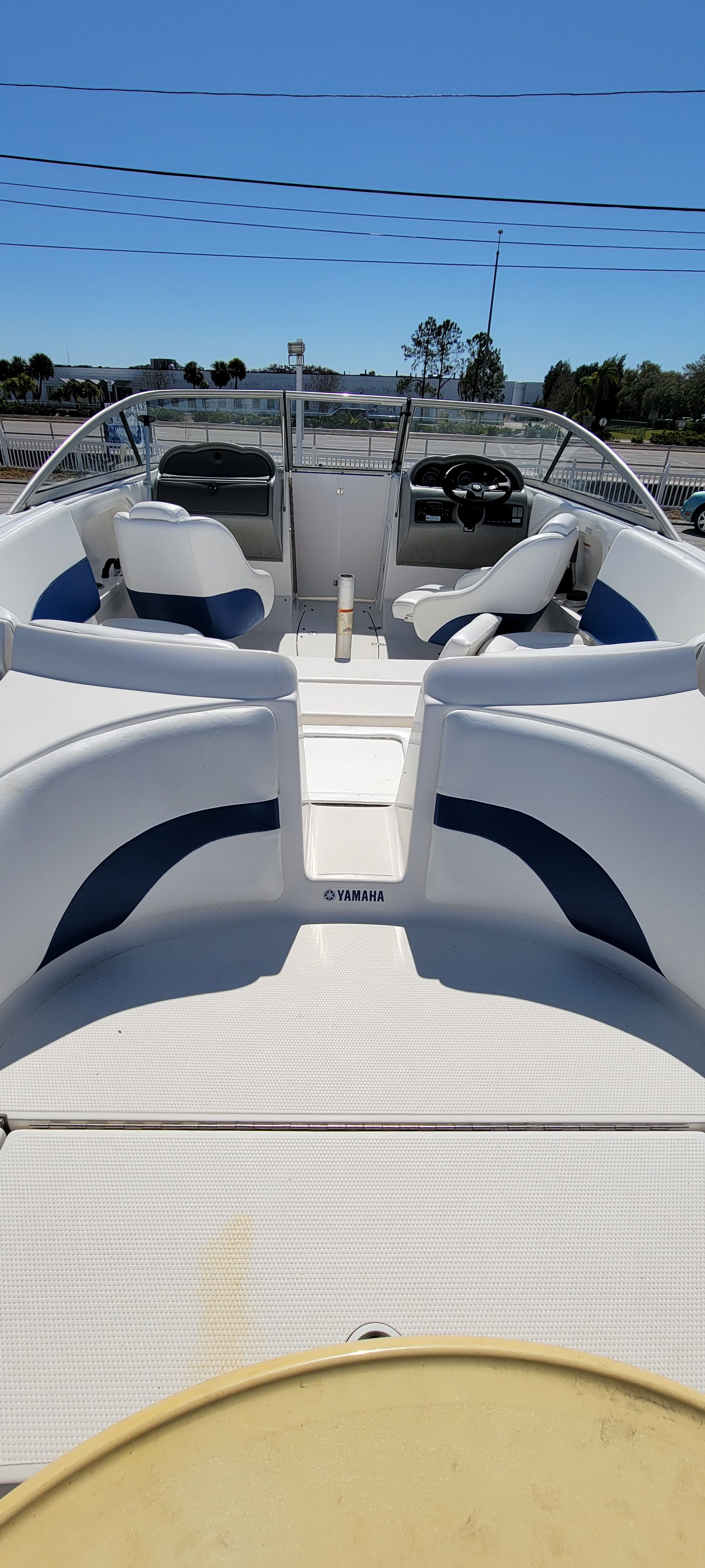 Yamaha Boats SX230 2006 Yamaha Boats SX230 interior with seating and steering wheel under clear blue sky.