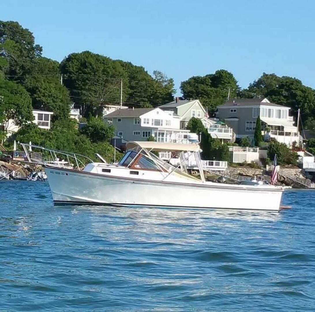 Fortier 26 Fortier 26 boat from 2000 on calm water near coastal homes.