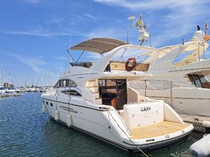 Princess 45 Flybridge Motor Yacht 2002 Princess 45 Flybridge yacht docked in a marina under a clear blue sky.