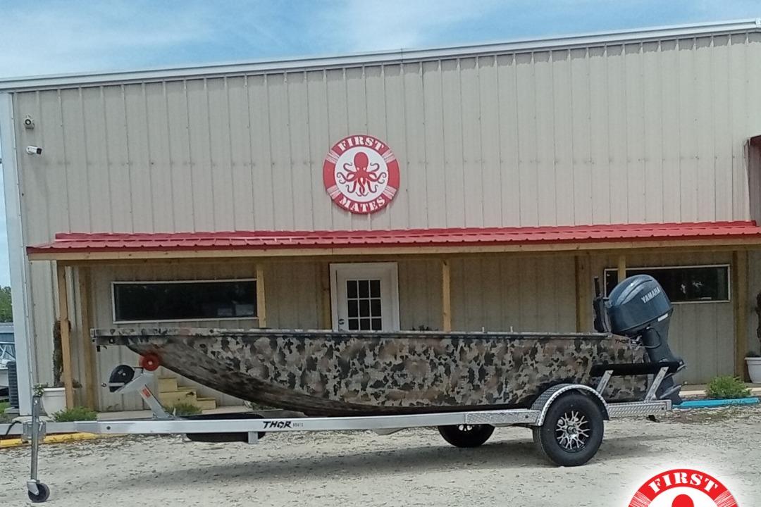 Thor 1754 Timber Hammer 2026 Thor 1754 Timber Hammer boat on trailer, camo design, outside First Mates building.