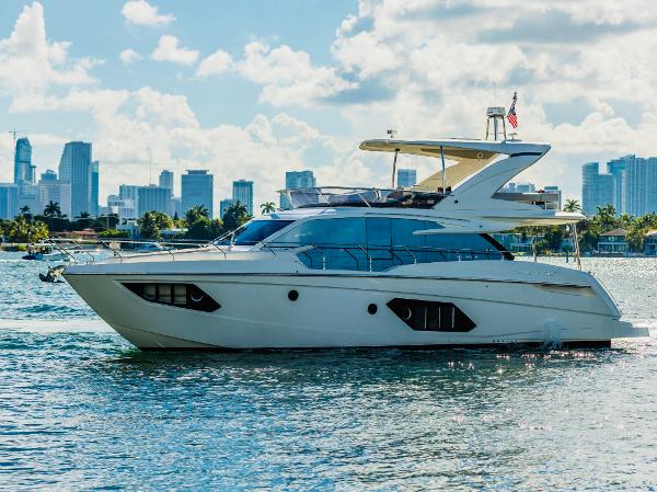 Absolute 52 FLY Luxury Absolute 52 FLY yacht cruising near city skyline, 2018 model.