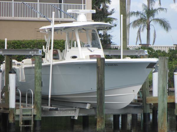 Cobia 301 Center Console 2018 Cobia 301 Center Console boat docked near waterfront property.