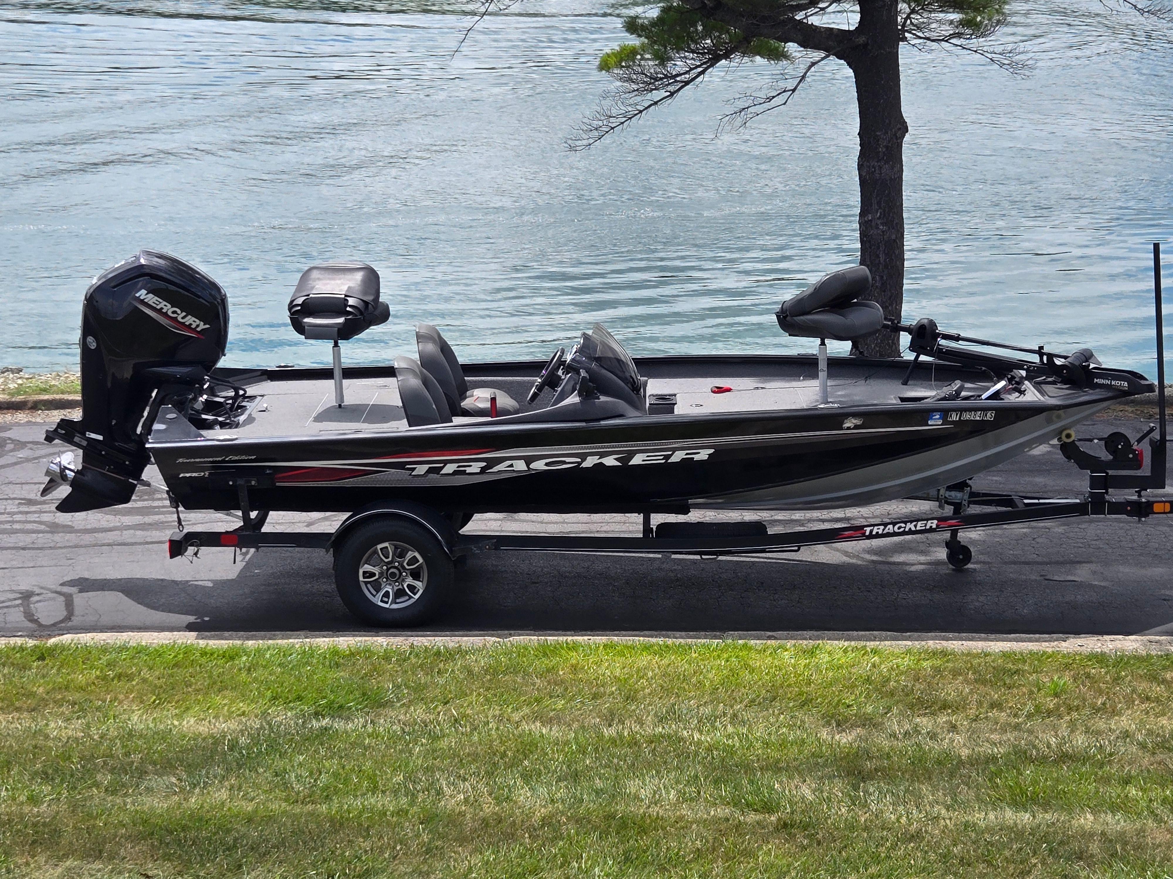 Tracker Pro Team 175 TXW 2023 Tracker Pro Team 175 TXW fishing boat on trailer by a lake.
