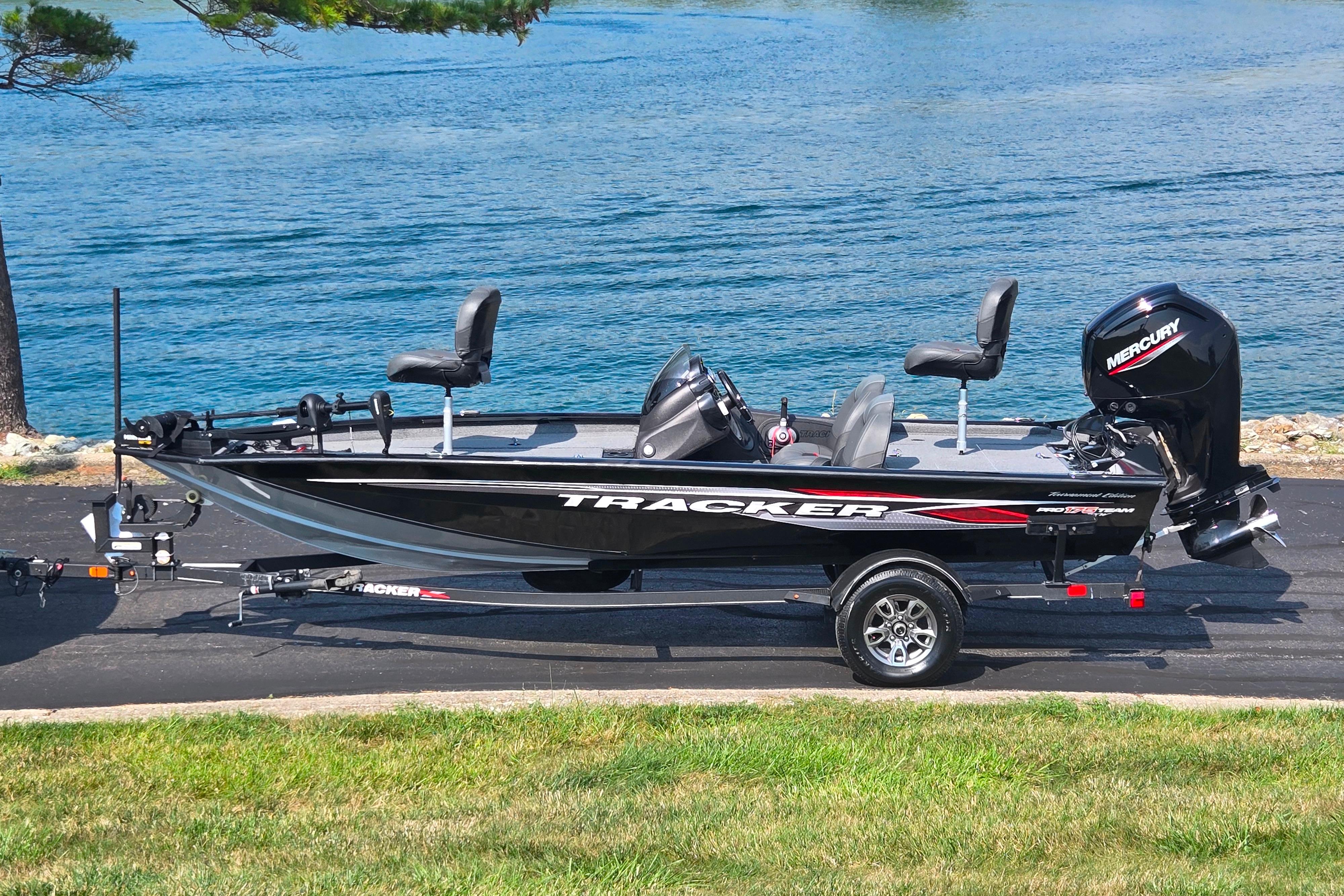 Tracker Pro Team 175 TXW 2023 Tracker Pro Team 175 TXW fishing boat on trailer by a lake.