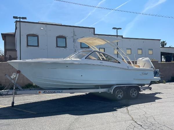 Scout 240 Dorado 2024 Scout 240 Dorado boat on a trailer in a parking lot.