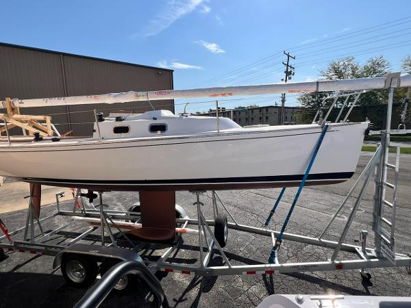 Tartan Fantail 2025 Tartan Fantail sailboat on trailer, parked outdoors under clear blue sky.