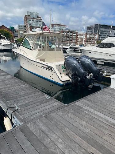 Grady-White 330 Express 2020 Grady-White 330 Express boat docked in a marina with twin outboard engines.