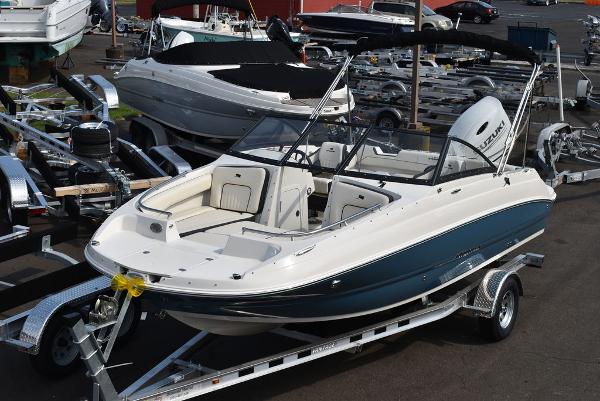 Stingray 201DC 2024 Stingray 201DC boat on a trailer in a marina.