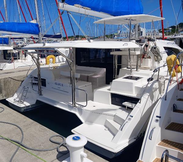 Leopard 40 2019 Leopard 40 catamaran docked, featuring blue sails and spacious deck.