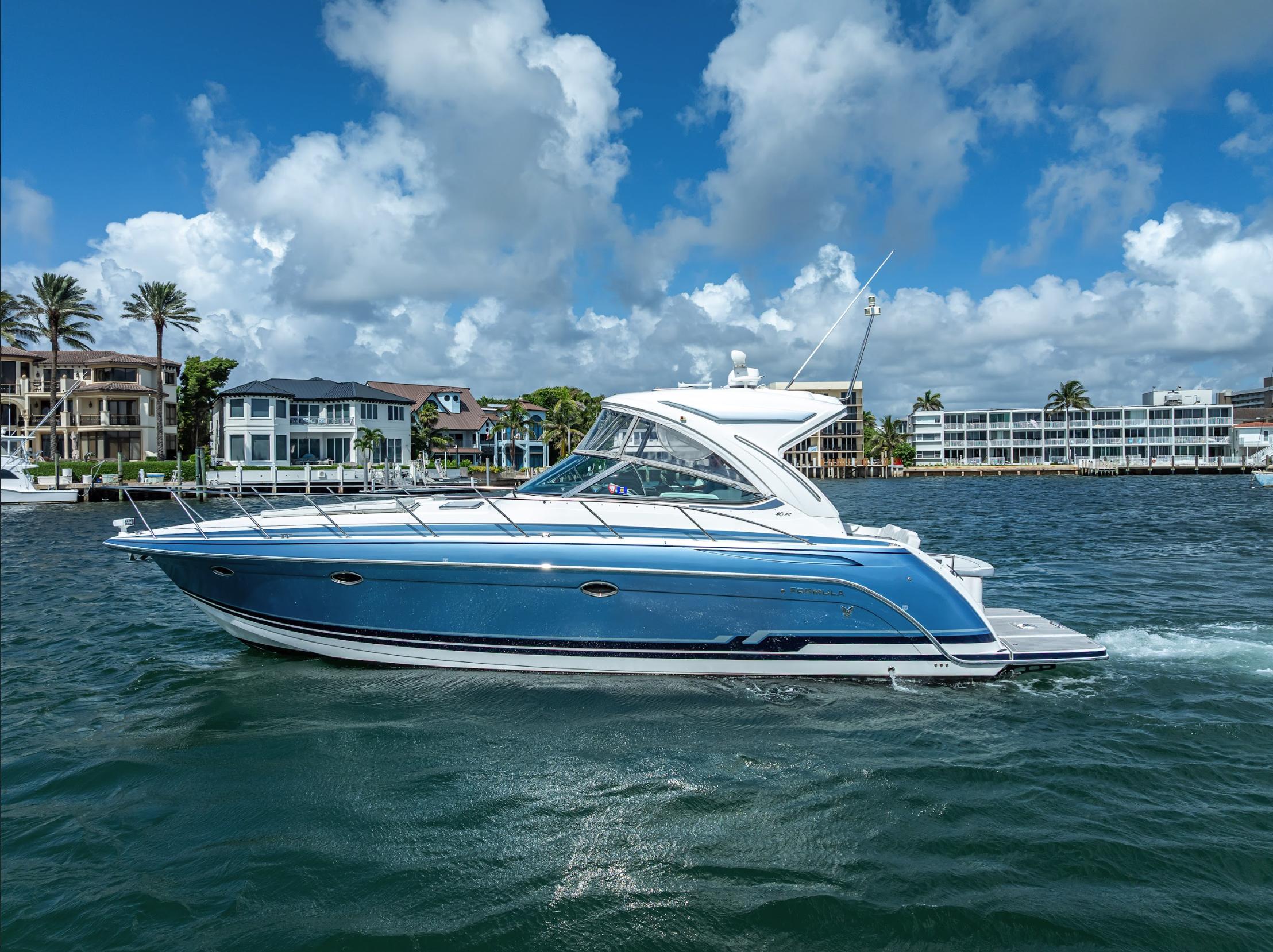 Formula 40 PC 2022 Formula 40 PC yacht cruising on a sunny day with waterfront homes in the background.