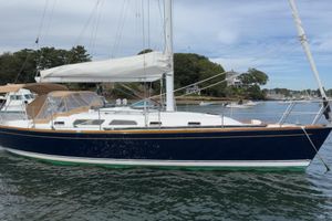 Sabre 386 2005 Sabre 386 sailboat with white sails docked in a scenic harbor.